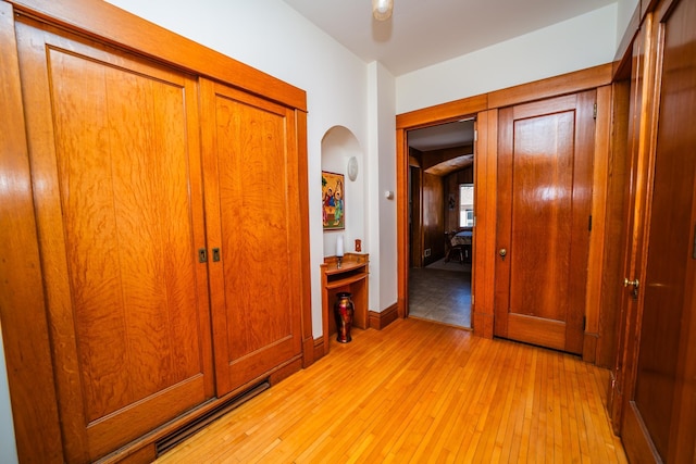 hallway with light wood-style floors and baseboards