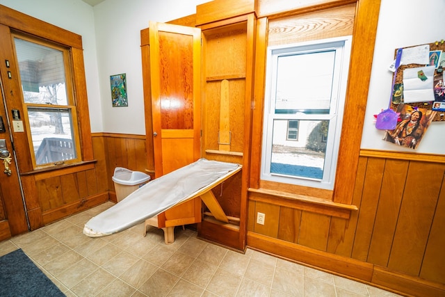 interior space featuring a wainscoted wall and wood walls