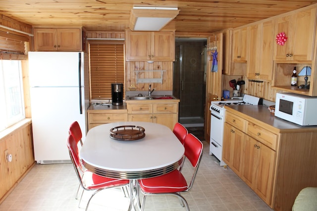 kitchen with white appliances, wooden ceiling, and light floors