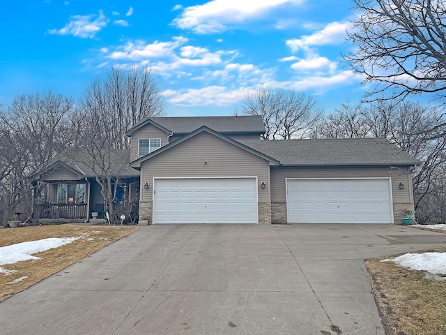 view of front of property featuring an attached garage, driveway, roof with shingles, and brick siding