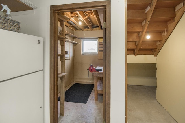 basement featuring freestanding refrigerator