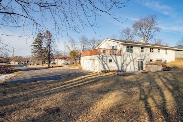 back of property featuring a lawn and stucco siding