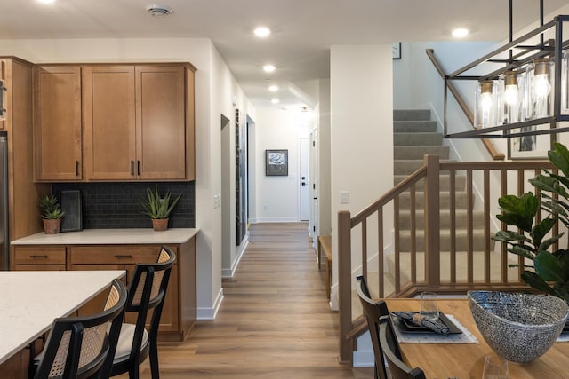 interior space featuring stairs, baseboards, wood finished floors, and recessed lighting