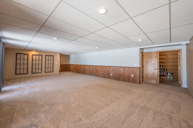 unfurnished room featuring recessed lighting, a wainscoted wall, wooden walls, and carpet flooring