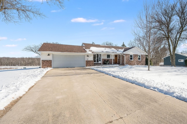 ranch-style home with a garage, concrete driveway, and brick siding