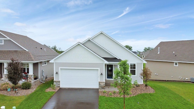 craftsman inspired home featuring a garage, stone siding, driveway, and a front lawn