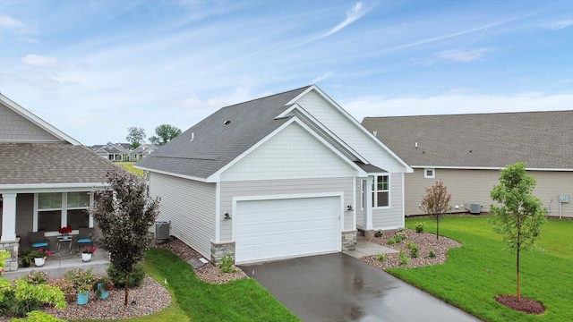 view of front facade with driveway, a garage, central AC unit, and a front lawn