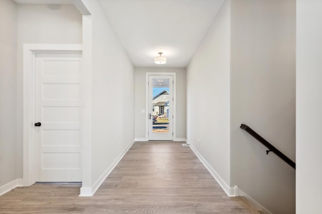 entryway featuring light wood finished floors and baseboards