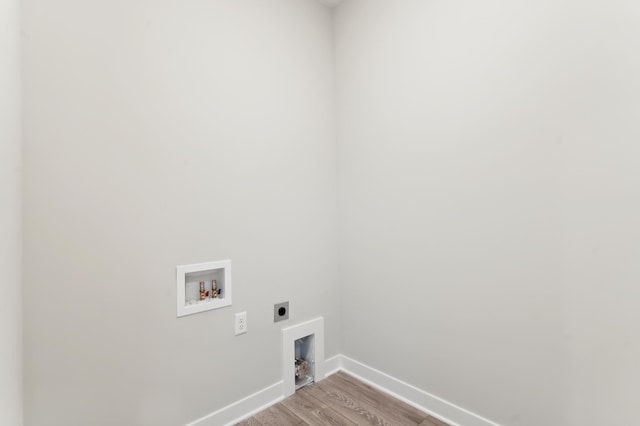 clothes washing area featuring washer hookup, light wood-style flooring, electric dryer hookup, laundry area, and baseboards