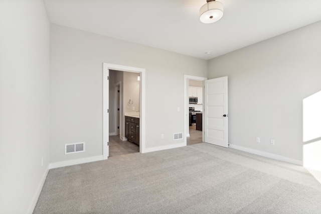 unfurnished bedroom with light colored carpet, visible vents, and baseboards