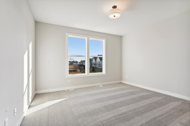 spare room with carpet floors and baseboards