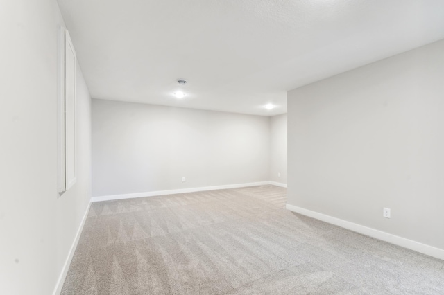 below grade area with light carpet and baseboards