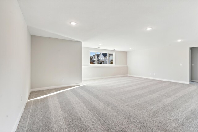 interior space featuring baseboards, light colored carpet, and recessed lighting