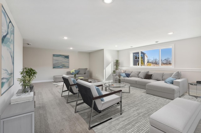 living area featuring baseboards and recessed lighting