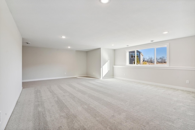 spare room featuring baseboards, carpet flooring, and recessed lighting