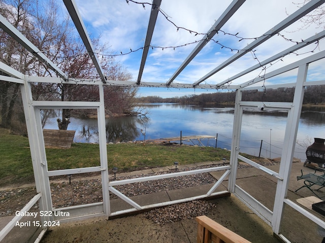 unfurnished sunroom with a water view