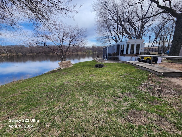 view of yard with a water view and a sunroom