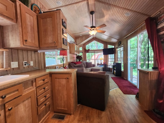 kitchen featuring lofted ceiling, wooden ceiling, plenty of natural light, and light countertops