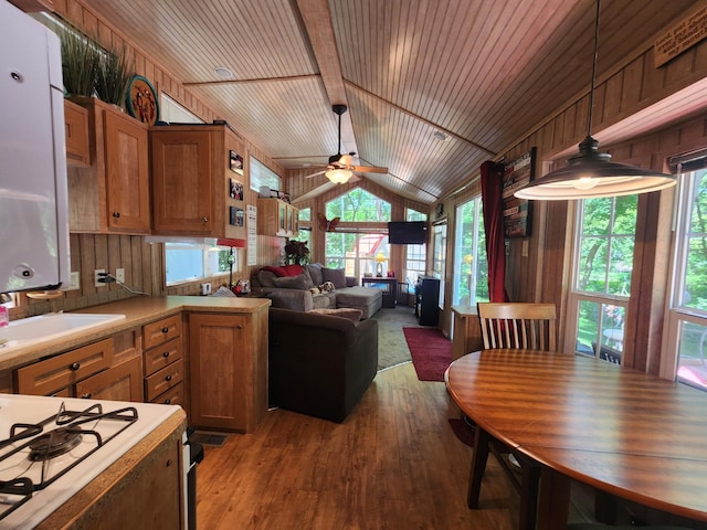 kitchen featuring wooden ceiling, wood walls, wood finished floors, vaulted ceiling, and open floor plan