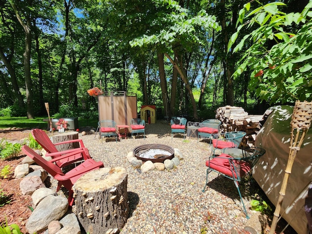 view of yard featuring an outdoor fire pit