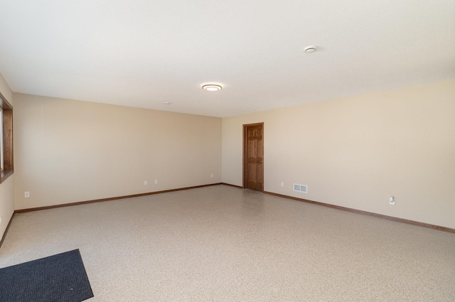 spare room with visible vents and baseboards