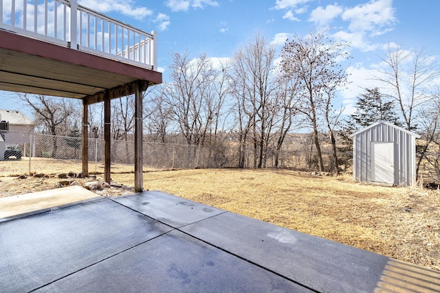 exterior space with a storage shed, a patio area, an outbuilding, and fence