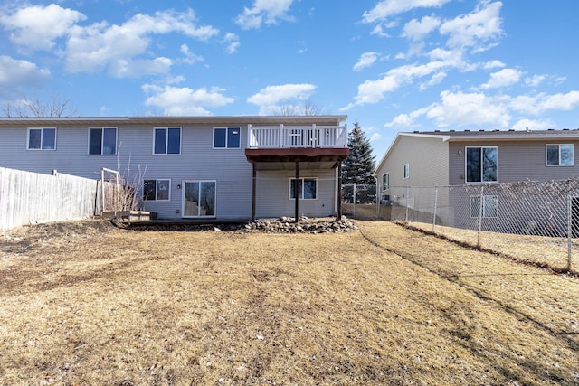 rear view of property featuring a fenced backyard