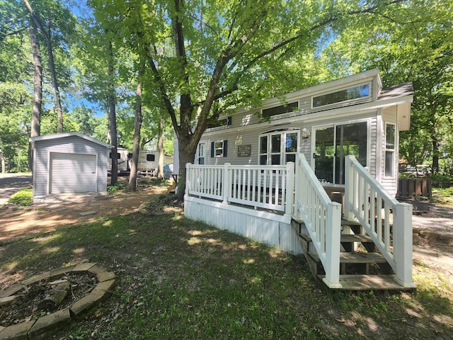 2945 County Road 4 SW Unit 118, Cokato, MN 55321 - back of property with a wooden deck, an outdoor structure, and a detached garage