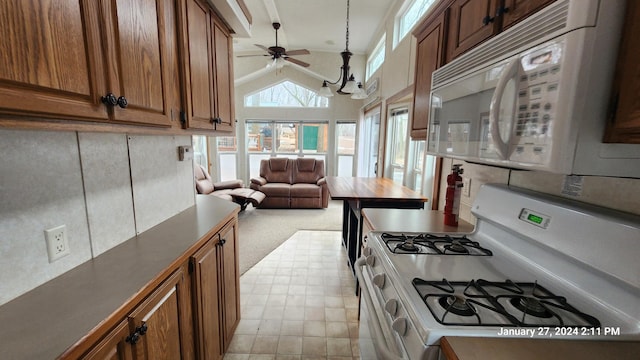 2945 County Road 4 SW Unit 118, Cokato, MN 55321 - kitchen with white appliances, open floor plan, a ceiling fan, dark countertops, and vaulted ceiling