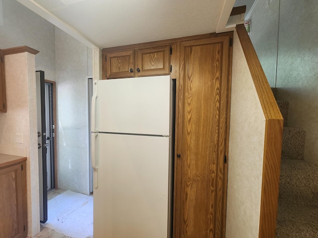 2945 County Road 4 SW Unit 118, Cokato, MN 55321 - kitchen with freestanding refrigerator and brown cabinetry