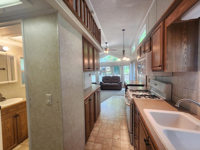 2945 County Road 4 SW Unit 118, Cokato, MN 55321 - kitchen with white appliances, a sink, a ceiling fan, and hanging light fixtures