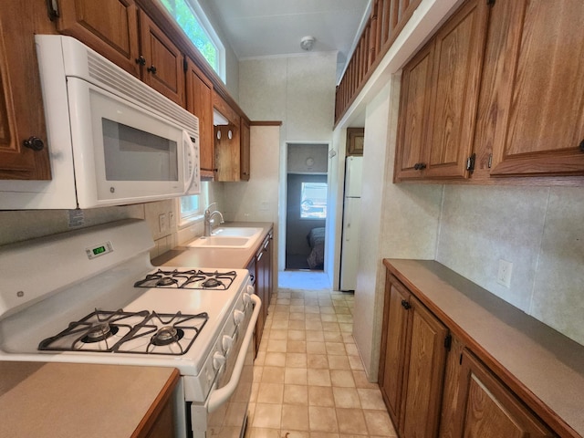 2945 County Road 4 SW Unit 118, Cokato, MN 55321 - kitchen featuring white appliances, a sink, brown cabinets, and light countertops