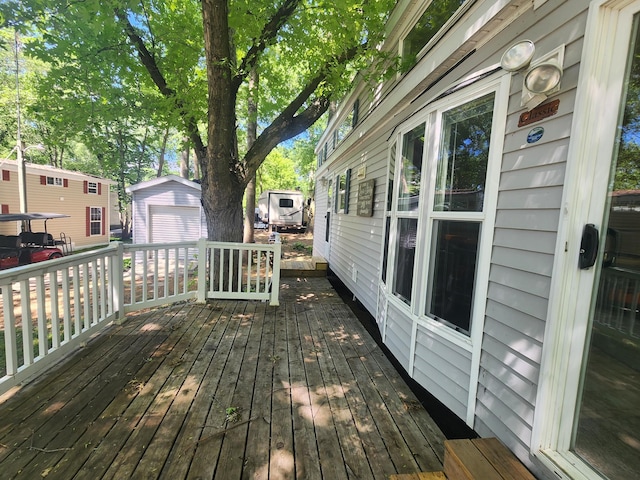 2945 County Road 4 SW Unit 118, Cokato, MN 55321 - deck with an outdoor structure and a detached garage