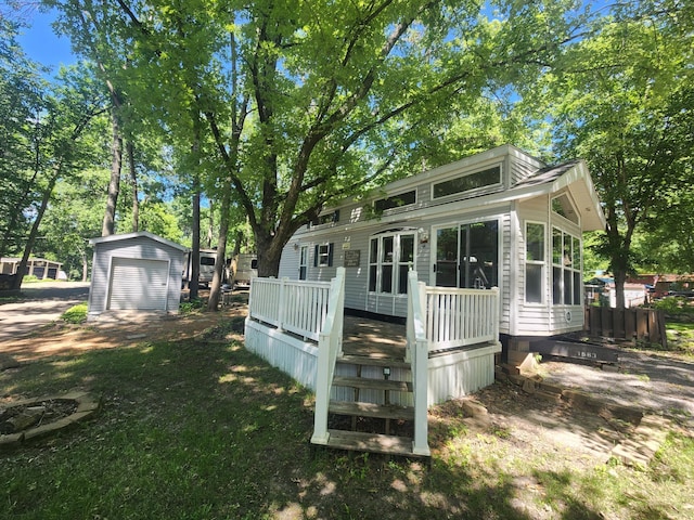 2945 County Road 4 SW Unit 118, Cokato, MN 55321 - back of house with a wooden deck and a detached garage