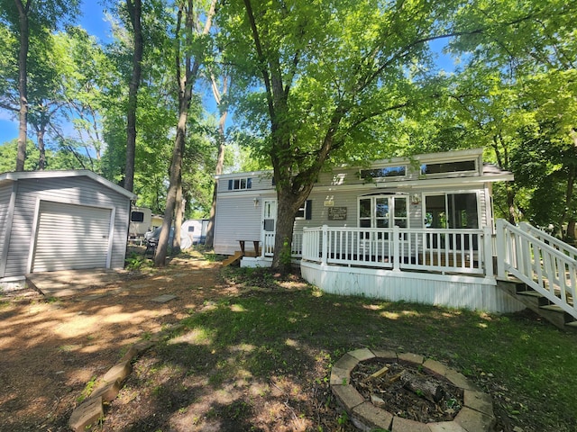 2945 County Road 4 SW Unit 118, Cokato, MN 55321 - view of yard with a fire pit, an outbuilding, a garage, and a deck
