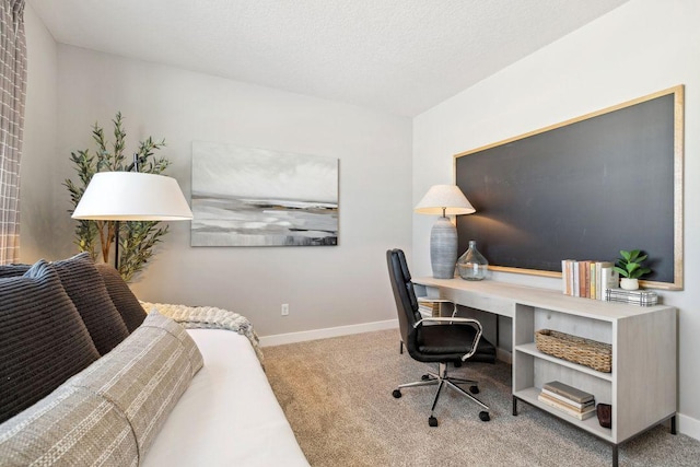 carpeted home office with baseboards and a textured ceiling