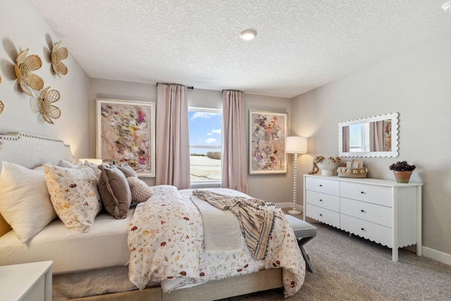 carpeted bedroom with baseboards and a textured ceiling