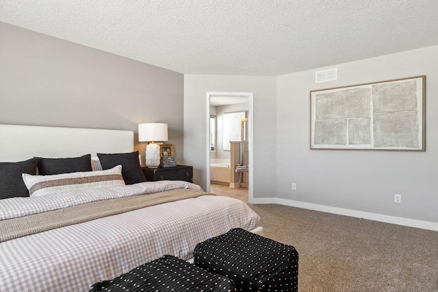 carpeted bedroom featuring ensuite bath, baseboards, visible vents, and a textured ceiling