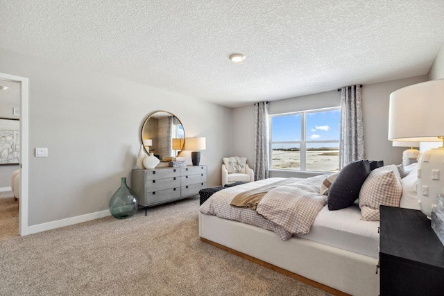 bedroom with baseboards, carpet, and a textured ceiling