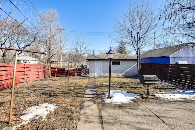 view of yard with a fenced backyard and an outdoor structure