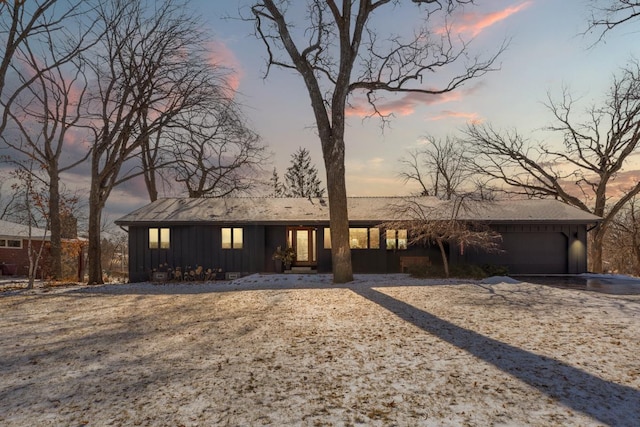 view of front of house featuring board and batten siding and an attached garage