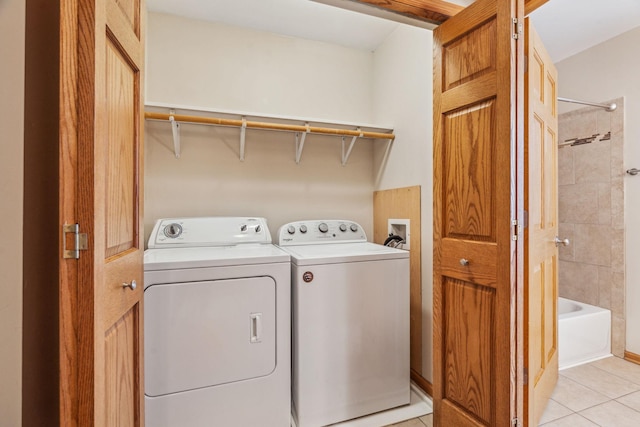 laundry room with laundry area, light tile patterned flooring, and independent washer and dryer