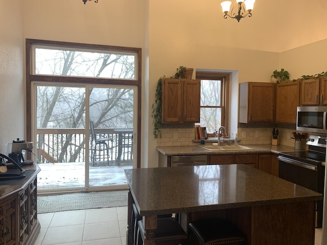 kitchen with a sink, decorative backsplash, plenty of natural light, and appliances with stainless steel finishes