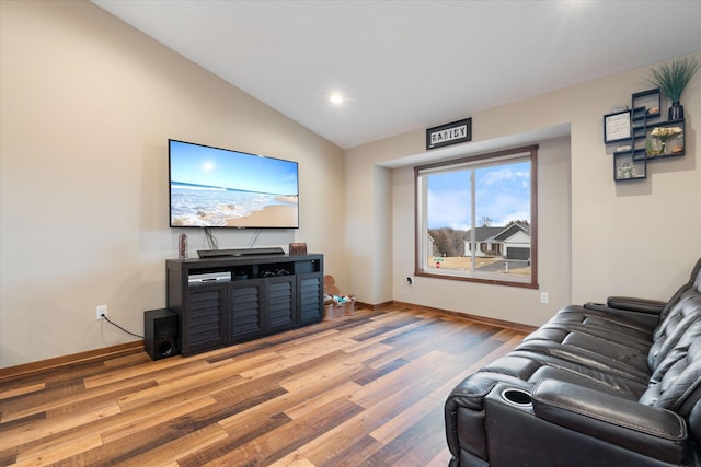 living area with lofted ceiling, baseboards, light wood finished floors, and recessed lighting