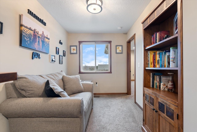 living room featuring baseboards, a textured ceiling, and light colored carpet