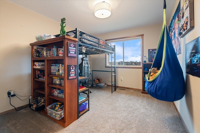 carpeted bedroom featuring a textured ceiling and baseboards