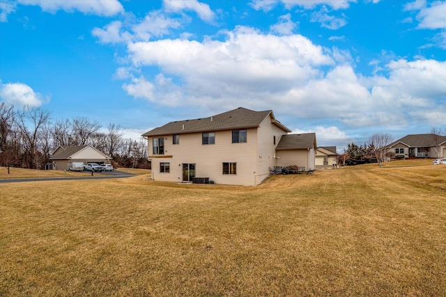 rear view of property featuring a yard