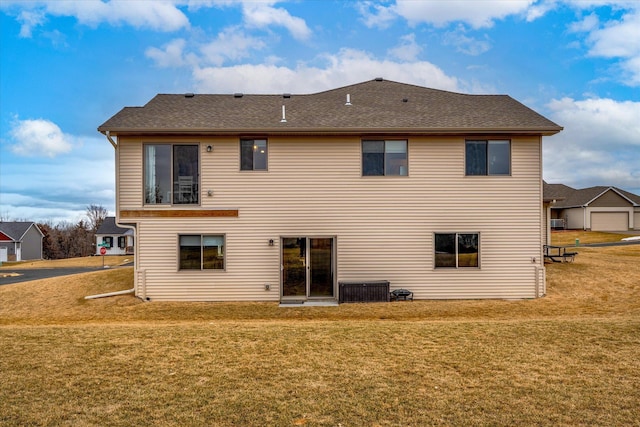 back of property featuring a lawn