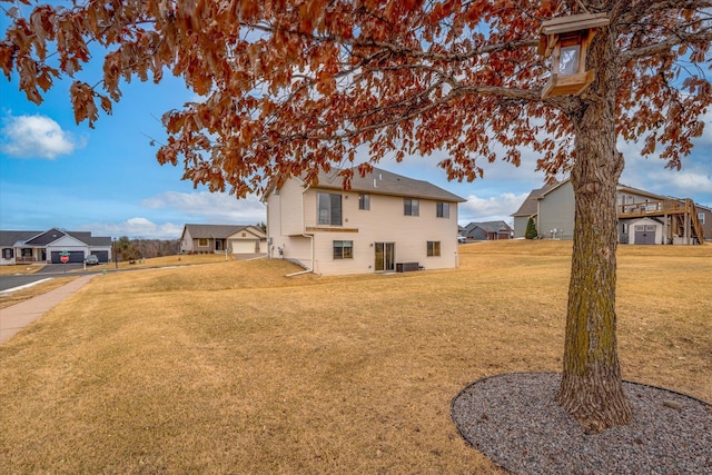 view of yard featuring a residential view and central AC