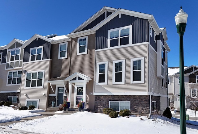 view of front of house with stone siding and board and batten siding